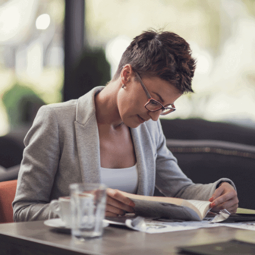 Woman in a smart jacket reading a book Woman in a smart jacket reading a book